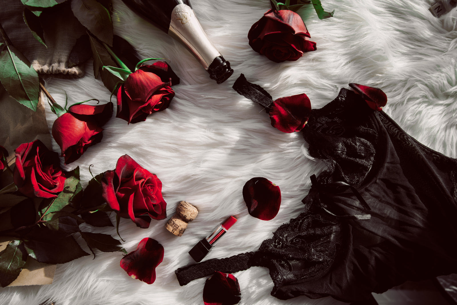 Rose petals and dark chocolate arranged on a surface